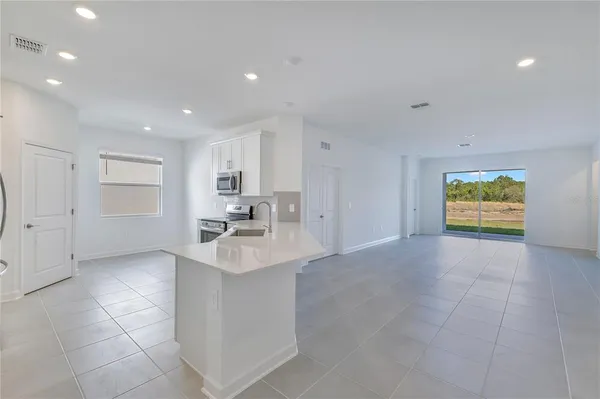 a view of kitchen with stainless steel appliances granite countertop a sink and dishwasher with a granite countertops