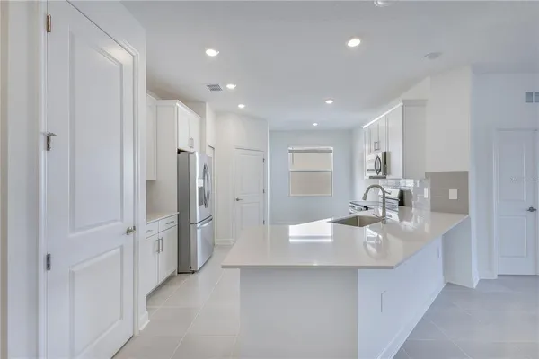 a bathroom with a double vanity sink mirror and shower