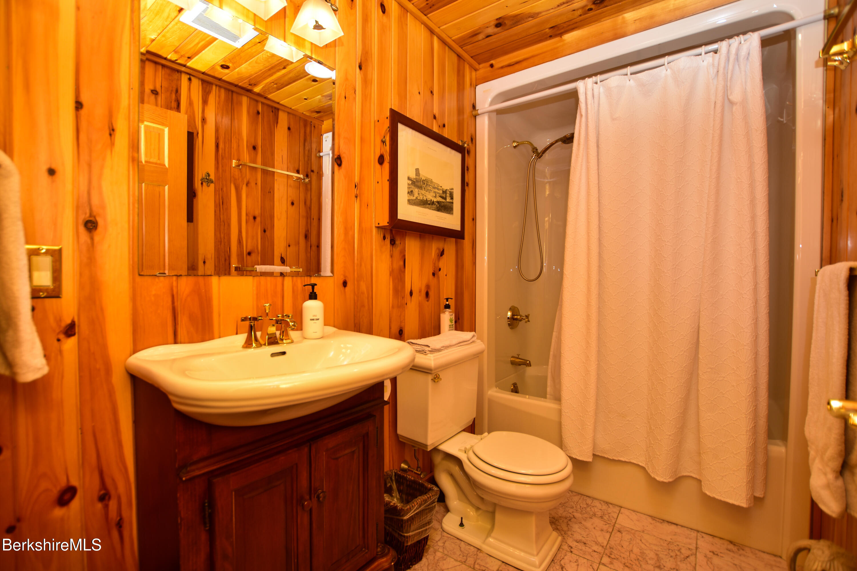 233 Algerie Road Becket, MA 01223 - Photo 18 of 48 a bathroom with a sink a toilet and shower curtain