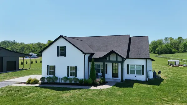 a view of a house with a yard and plants