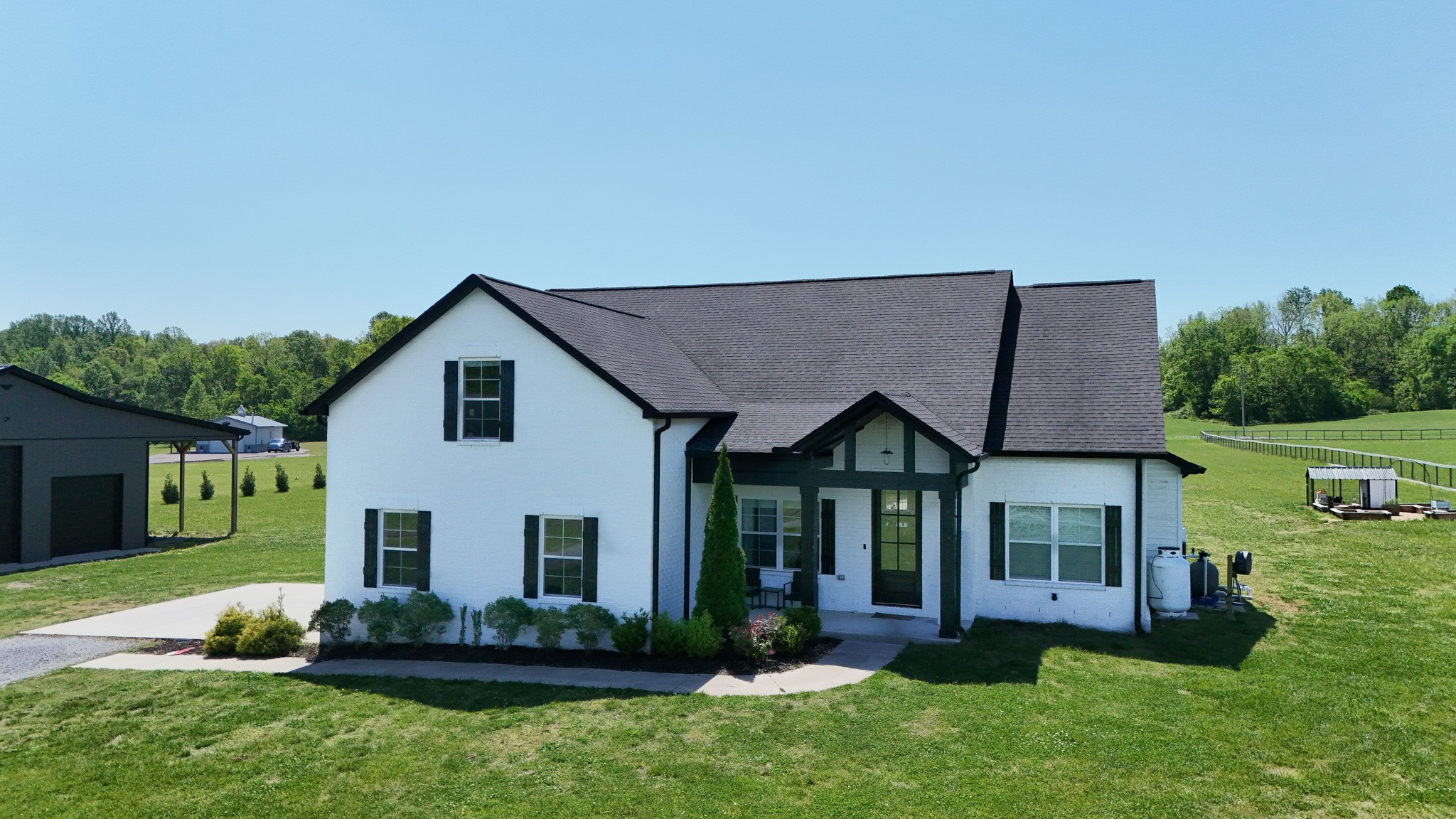 a view of a house with a yard and plants