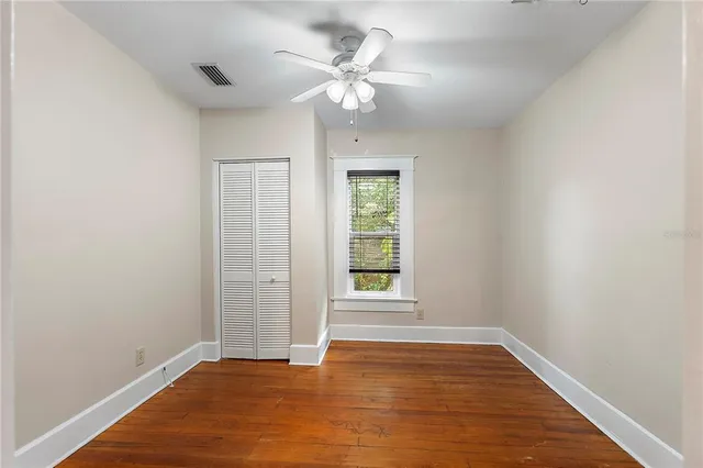 wooden floor in an empty room with a window