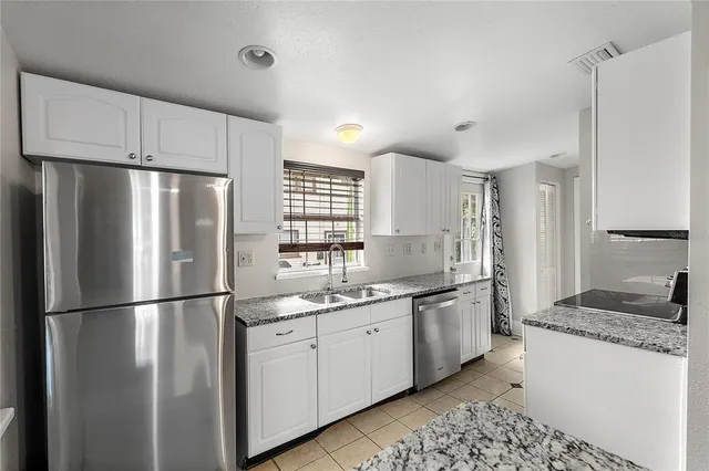 a kitchen with granite countertop a stove and a sink