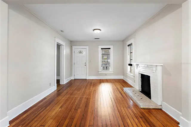 wooden floor in an empty room with a fireplace