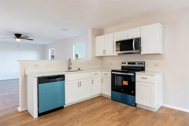a kitchen with stainless steel appliances granite countertop a stove top oven and sink