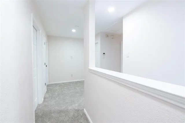 a view of empty room with ceiling fan