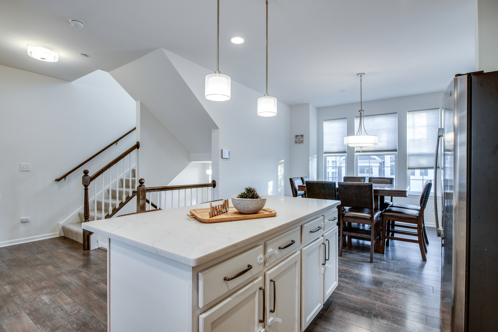 4477 Monroe Court Naperville, IL 60564 - Photo 8 of 23 a kitchen with a table chairs stove and cabinets