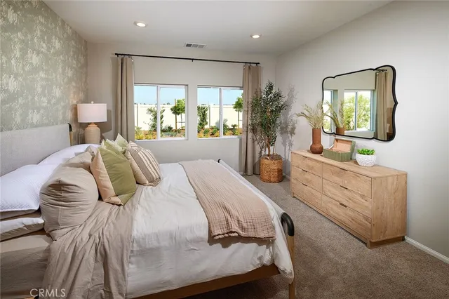 a bedroom with a bed and a large mirror in it