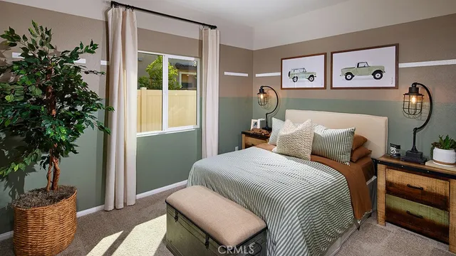 a bedroom with a bed and a potted plant