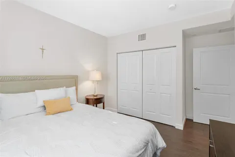 a bedroom with a bed and a night stand