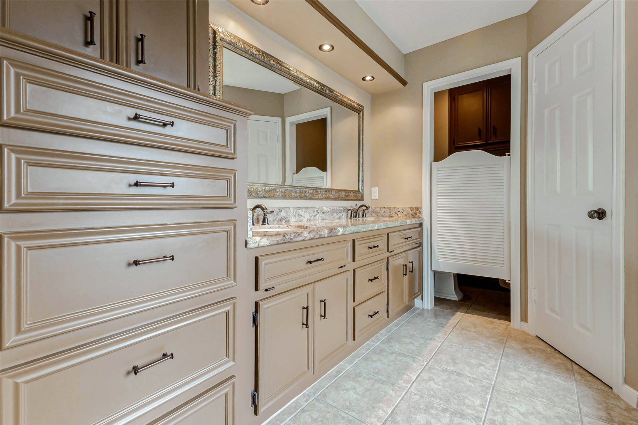 15811 Spring Forest Drive Houston, TX 77059 - Photo 20 of 27 Discover elegance in this primary bath featuring sleek cabinetry, a spacious dual-sink vanity, and a sophisticated design that invites relaxation and style.