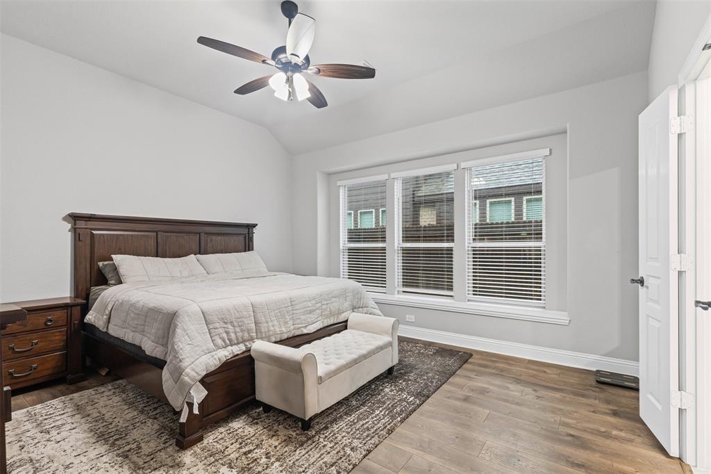 1013 Stockton Drive Godley, TX 76044 - Photo 12 of 22 a bed sitting in a bedroom next to a window and a chandelier