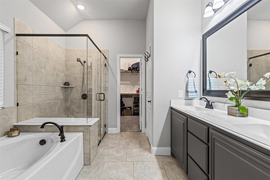 1013 Stockton Drive Godley, TX 76044 - Photo 13 of 22 a bathroom with a tub sink and mirror
