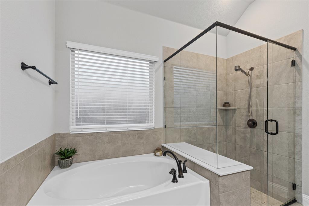 1013 Stockton Drive Godley, TX 76044 - Photo 14 of 22 a bathroom with a bathtub and shower