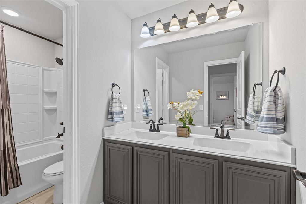 1013 Stockton Drive Godley, TX 76044 - Photo 17 of 22 a bathroom with a double vanity sink mirror and double