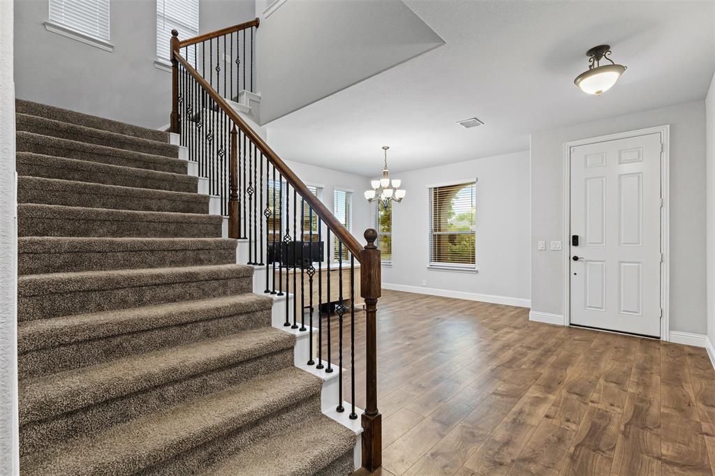 1013 Stockton Drive Godley, TX 76044 - Photo 4 of 22 a view of entryway and hall with wooden floor