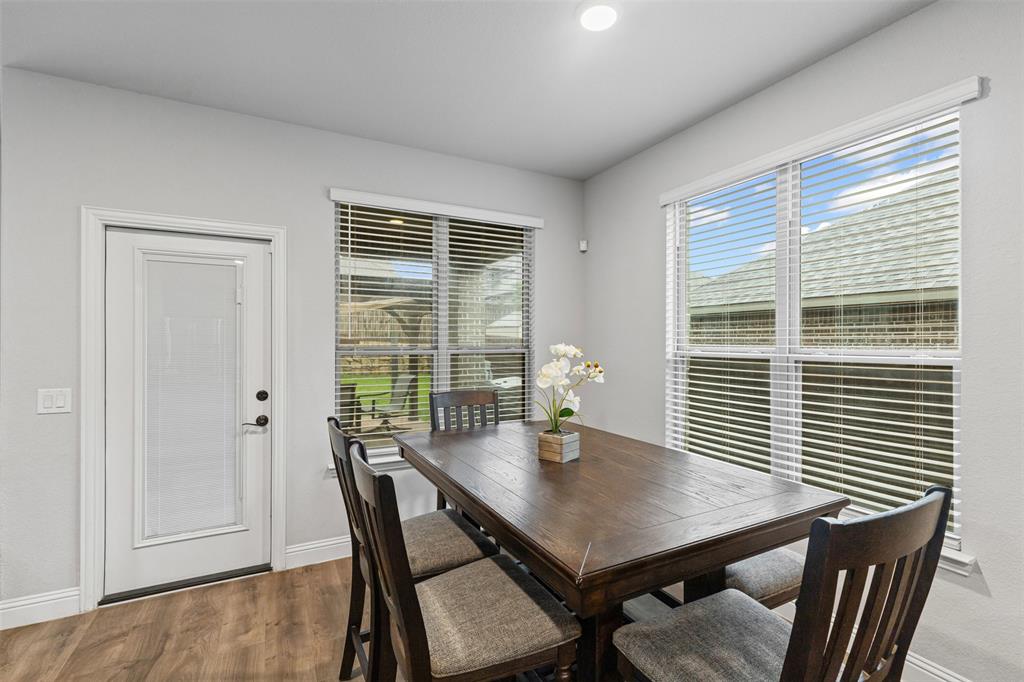 1013 Stockton Drive Godley, TX 76044 - Photo 7 of 22 a view of a dining room with furniture and wooden floor