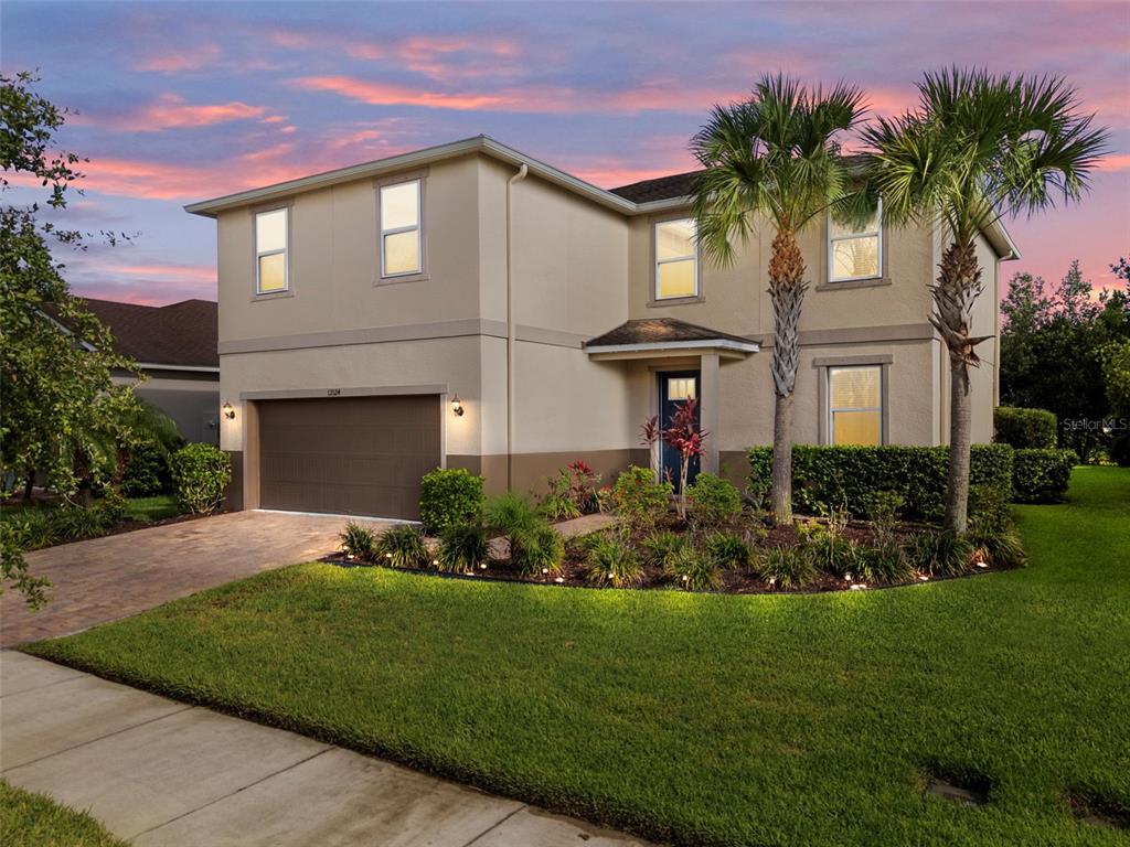 a front view of a house with a garden