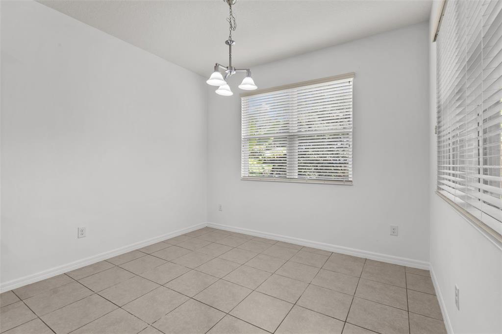 12124 Lake Boulevard Trinity, FL 34655 - Photo 12 of 31 an empty room with chandelier fan