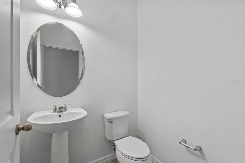 12124 Lake Boulevard Trinity, FL 34655 - Photo 14 of 31 a bathroom with a sink a toilet and a mirror