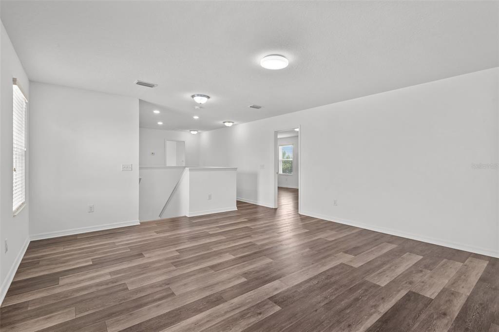 12124 Lake Boulevard Trinity, FL 34655 - Photo 18 of 31 a view of an empty room with wooden floor