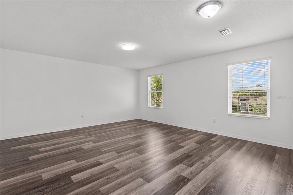 12124 Lake Boulevard Trinity, FL 34655 - Photo 19 of 31 an empty room with wooden floor and windows