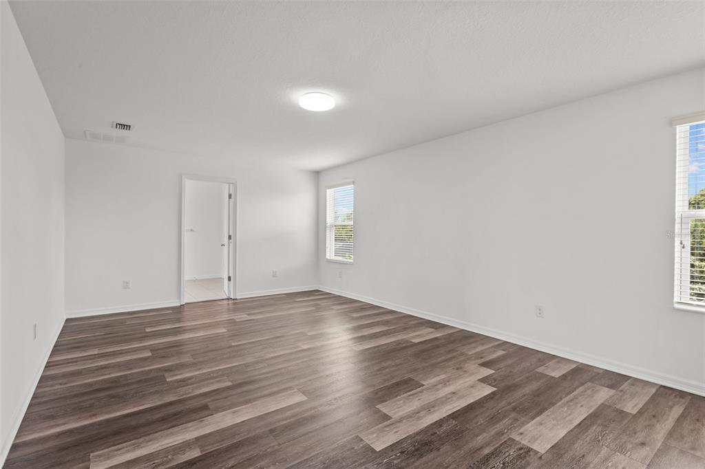 12124 Lake Boulevard Trinity, FL 34655 - Photo 20 of 31 a view of an empty room with wooden floor and a window