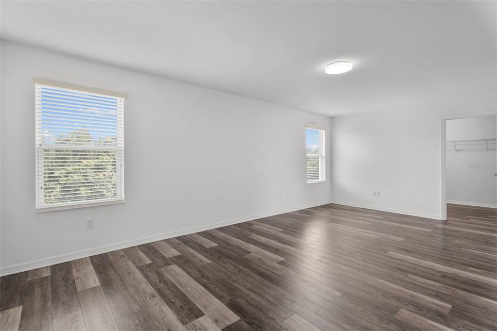 12124 Lake Boulevard Trinity, FL 34655 - Photo 24 of 31 an empty room with wooden floor and windows