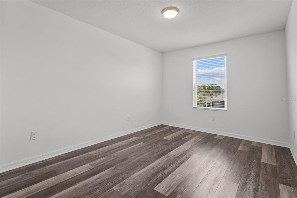 12124 Lake Boulevard Trinity, FL 34655 - Photo 28 of 31 an empty room with wooden floor and windows