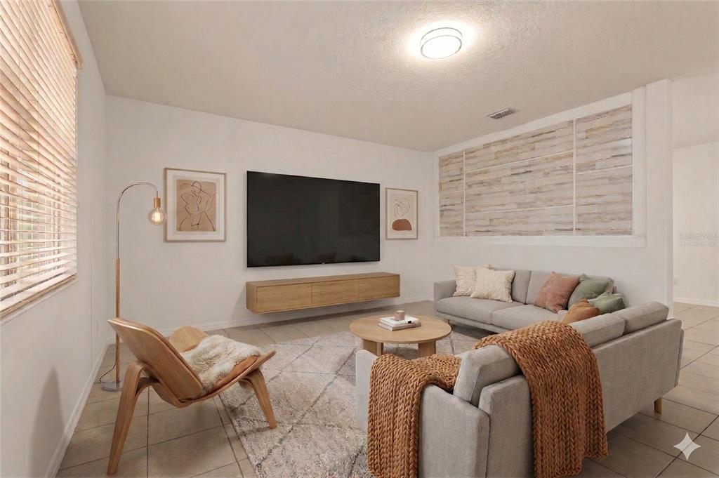 12124 Lake Boulevard Trinity, FL 34655 - Photo 3 of 31 a living room with furniture and a flat screen tv