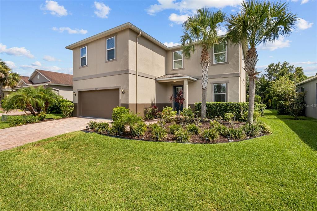 12124 Lake Boulevard Trinity, FL 34655 - Photo 31 of 31 a front view of a house with a garden