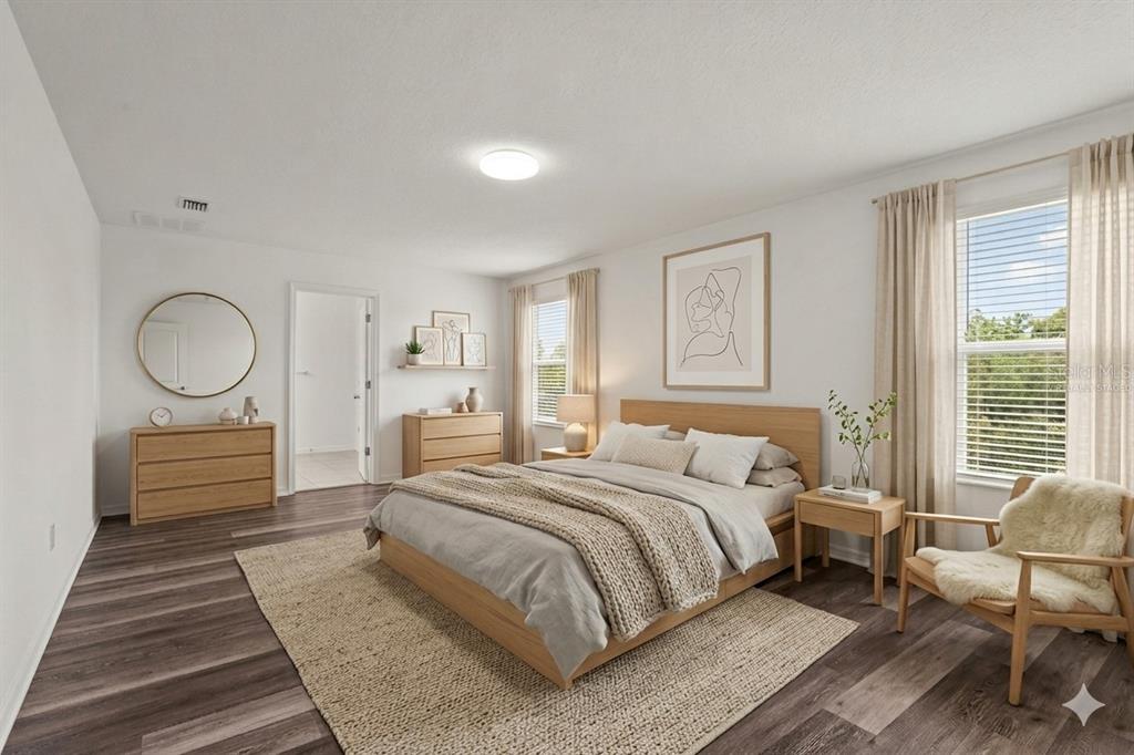 12124 Lake Boulevard Trinity, FL 34655 - Photo 6 of 31 a bedroom with a large bed and wooden floor