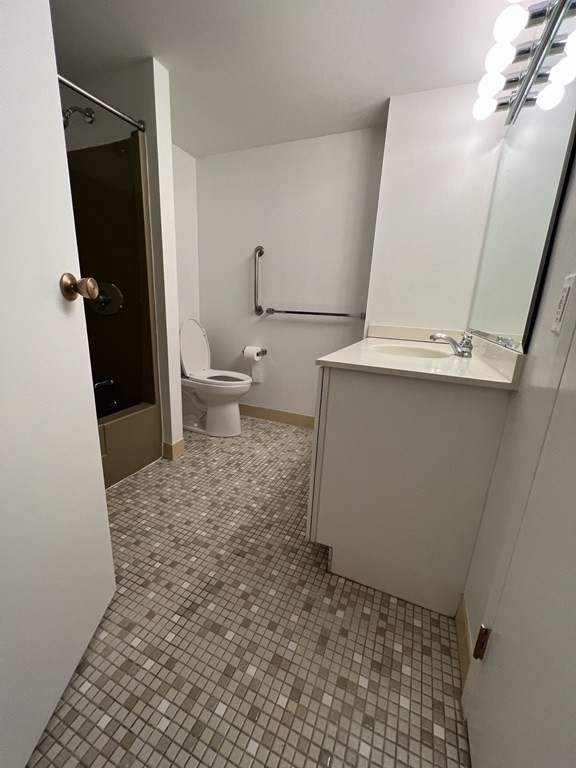 1550 Worcester Road, Unit 114 Framingham, MA 01702 - Photo 12 of 29 a bathroom with a sink and a toilet