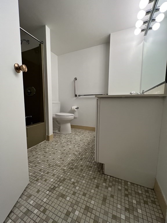 1550 Worcester Road, Unit 114 Framingham, MA 01702 - Photo 13 of 29 a bathroom with a sink a toilet and shower