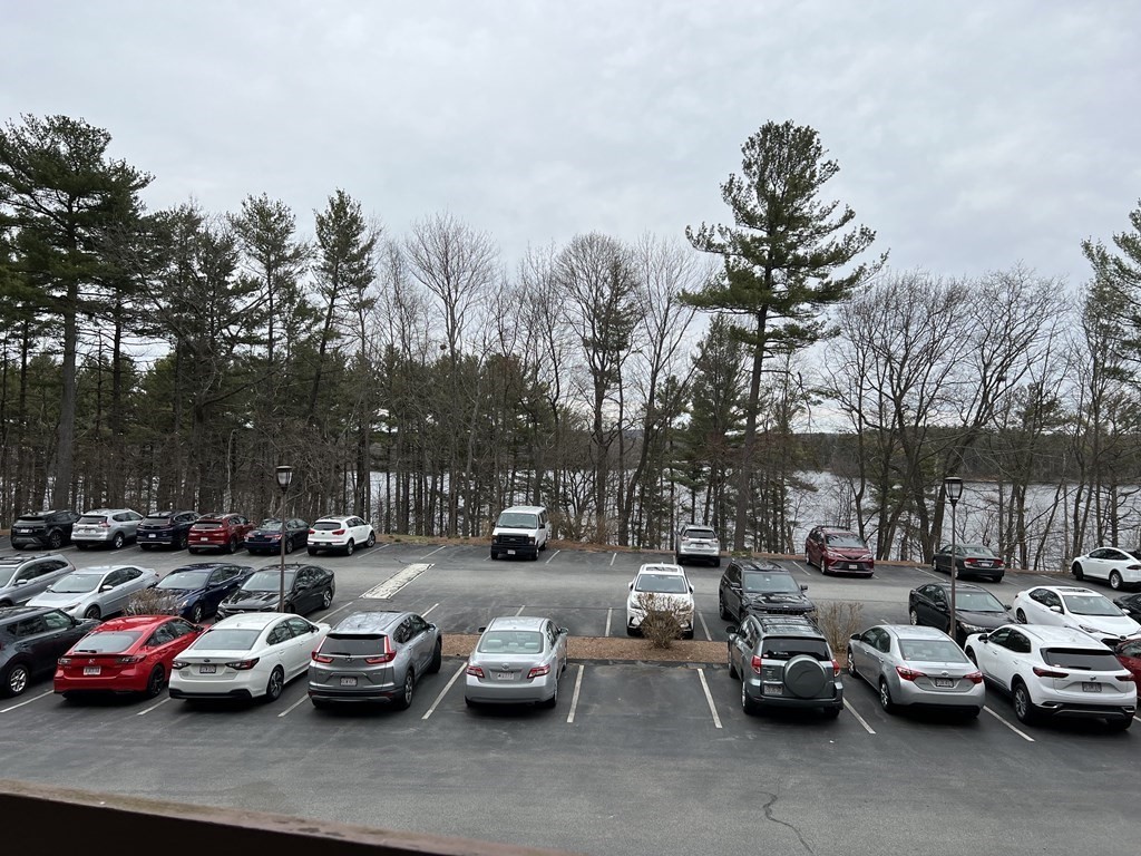 1550 Worcester Road, Unit 114 Framingham, MA 01702 - Photo 29 of 29 a group of cars parked in a parking lot at street side
