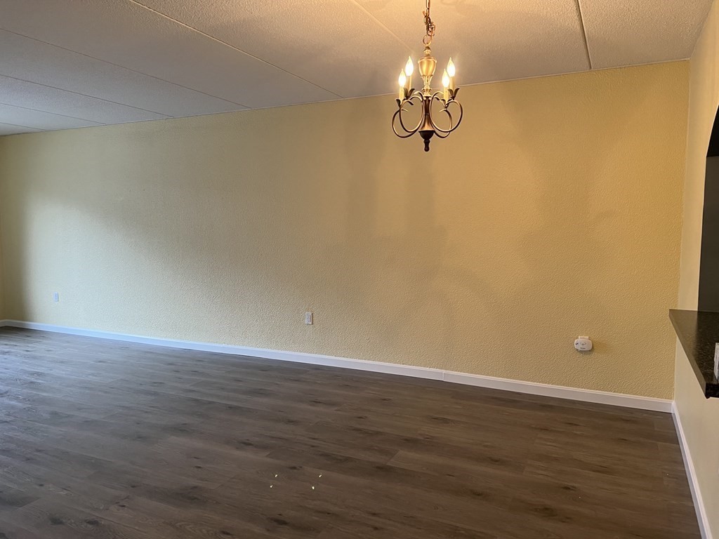 1550 Worcester Road, Unit 114 Framingham, MA 01702 - Photo 5 of 29 a view of a room with wooden floor and cabinets