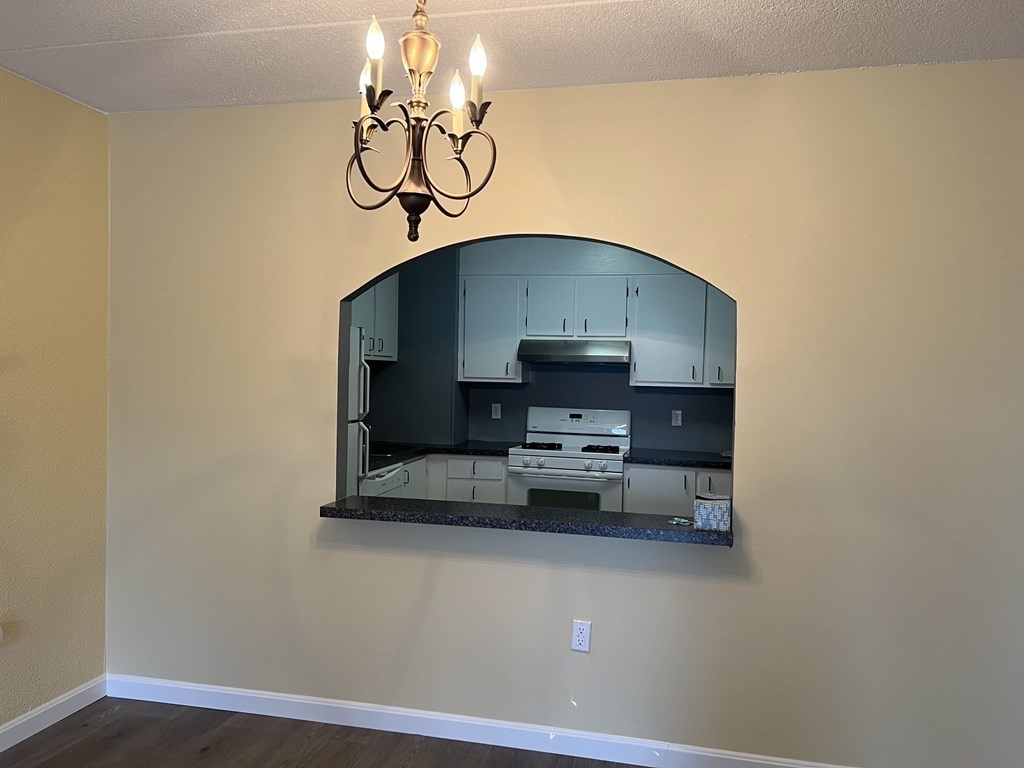 1550 Worcester Road, Unit 114 Framingham, MA 01702 - Photo 6 of 29 a view of livingroom and kitchen with a table