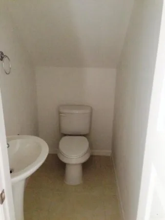 a white toilet sitting next to a white sink