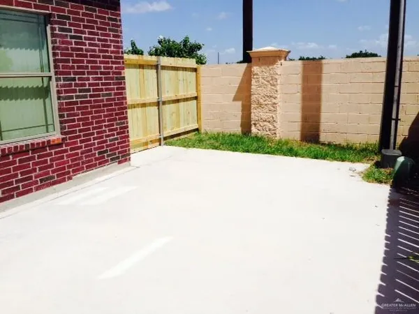a view of backyard with a fence