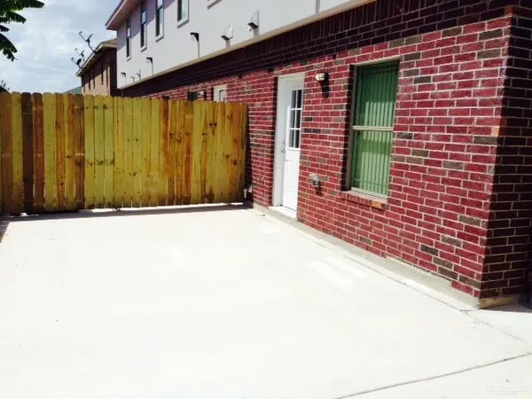 a view of a backyard with a wooden fence