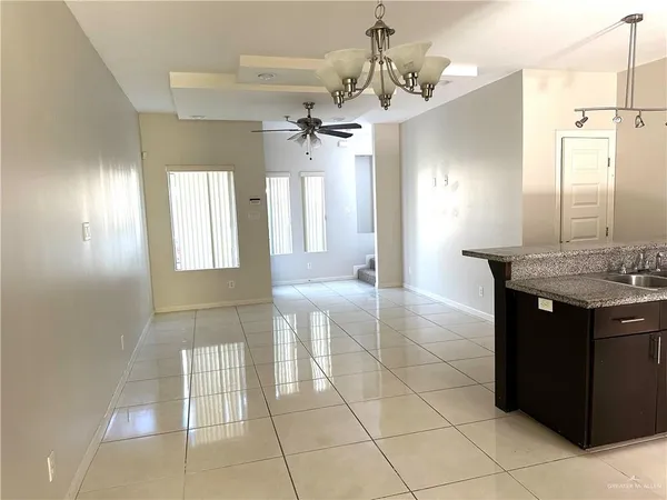 a spacious bathroom with a granite countertop sink a mirror and a shower