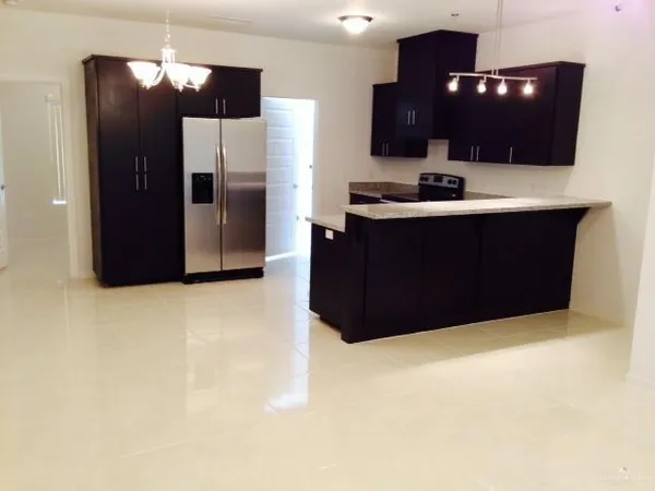 a kitchen with a refrigerator and cabinets