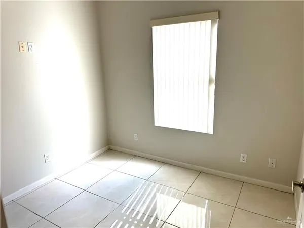a view of an empty room and a window