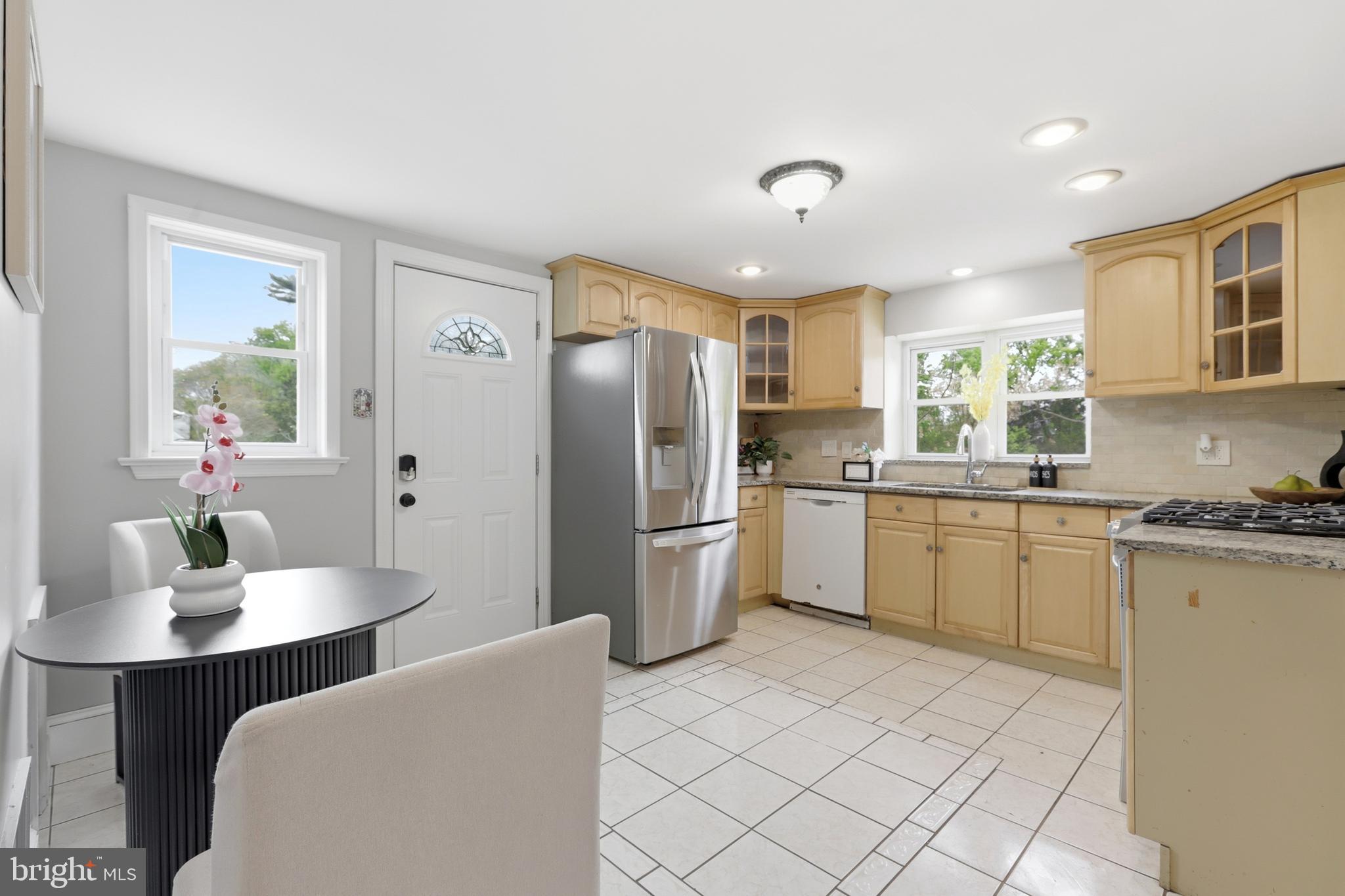 718 Chestnut Avenue Laurel Springs, NJ 08021 - Photo 14 of 49 a kitchen with a refrigerator and wooden cabinets
