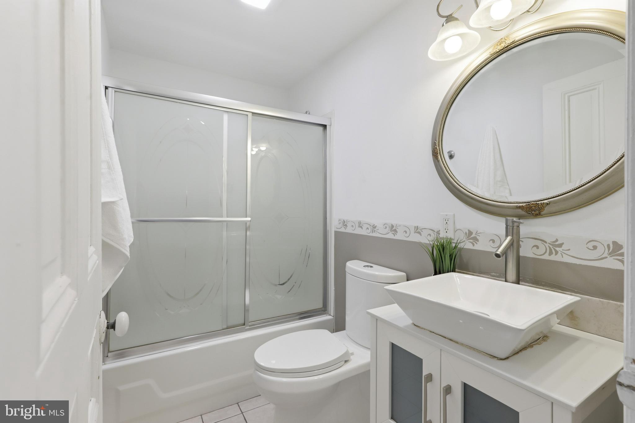718 Chestnut Avenue Laurel Springs, NJ 08021 - Photo 19 of 49 a bathroom with a toilet a sink and a mirror