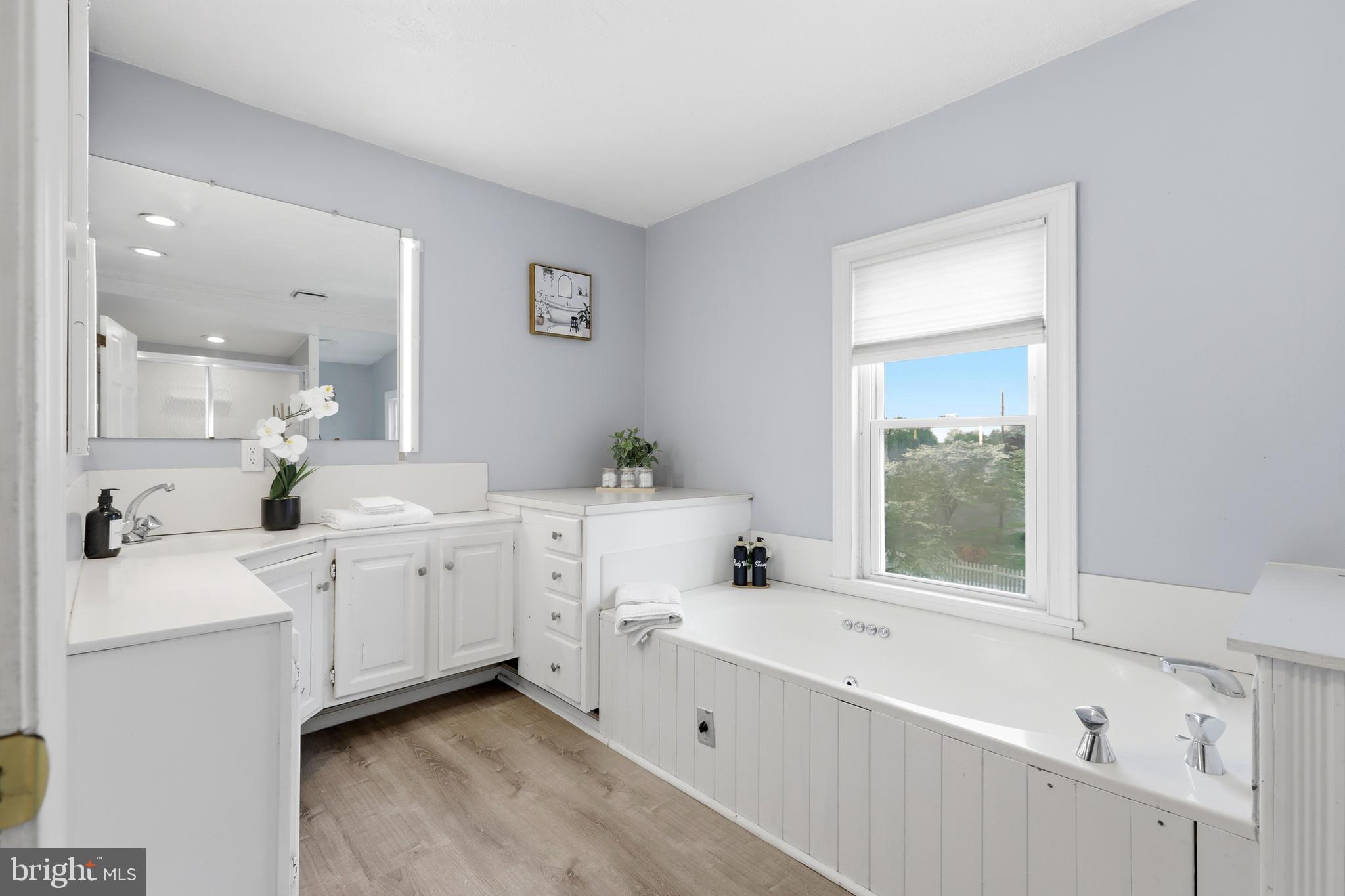 718 Chestnut Avenue Laurel Springs, NJ 08021 - Photo 26 of 49 a large white bathroom with a double vanity sink a mirror and a bathtub