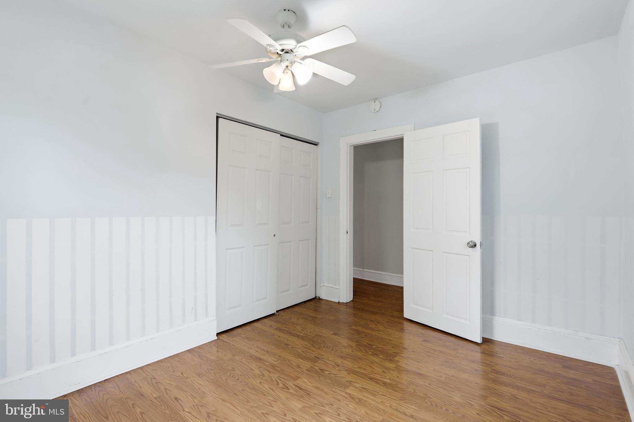 718 Chestnut Avenue Laurel Springs, NJ 08021 - Photo 27 of 49 an empty room with wooden floor and ceiling fan