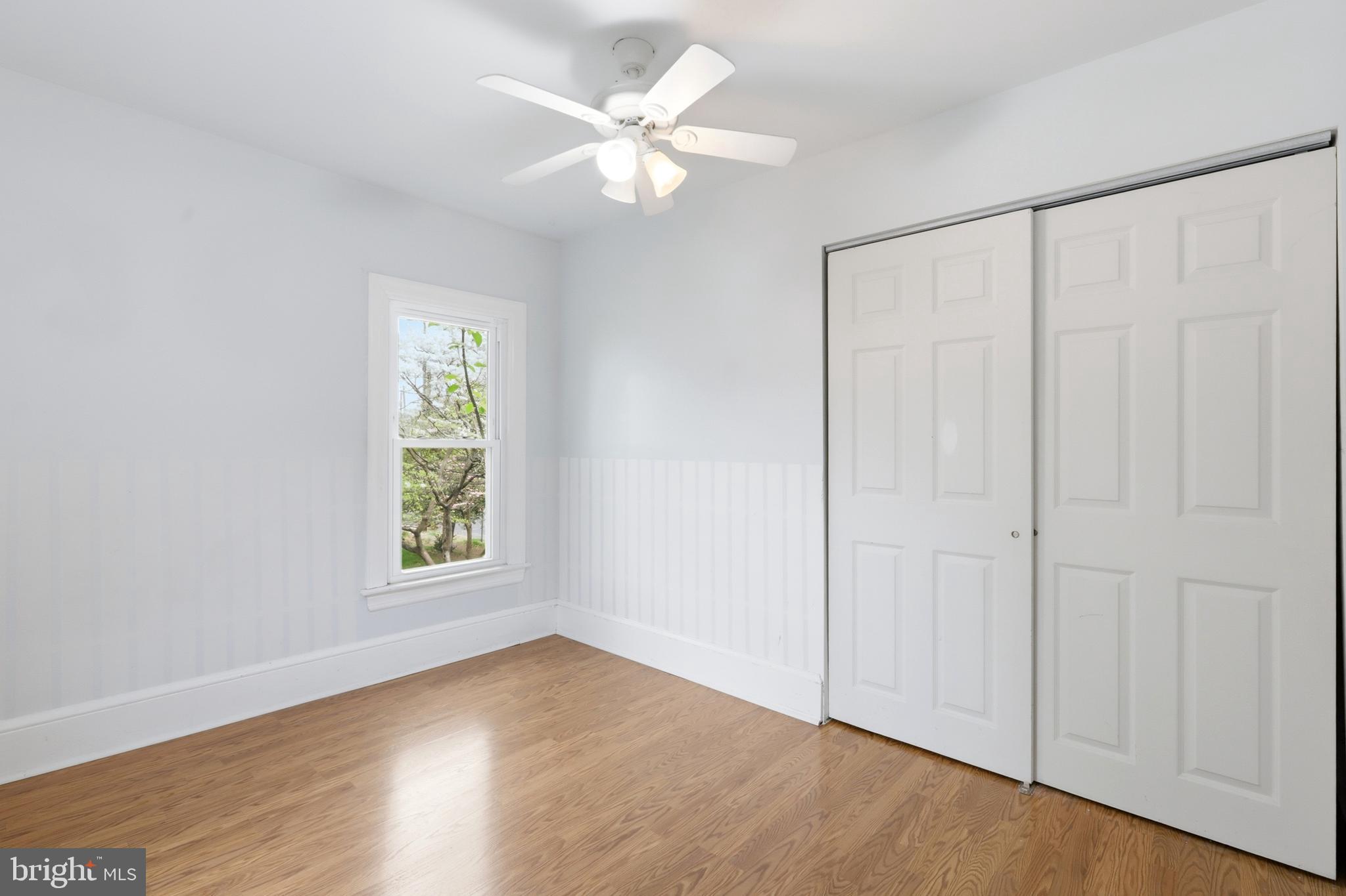 718 Chestnut Avenue Laurel Springs, NJ 08021 - Photo 28 of 49 an empty room with wooden floor fan and windows