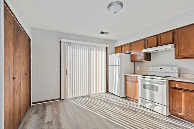 a kitchen with stainless steel appliances granite countertop a refrigerator and a stove top oven