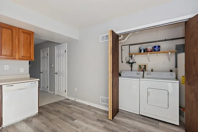 a utility room with cabinets washer and dryer